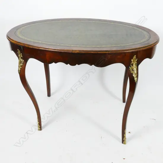 An elegant mahogany oval writing table of French Louis XV style