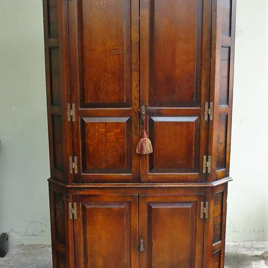 A Georgian style country oak standing corner cabinet