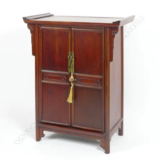 A Chinese teak small two door cabinet