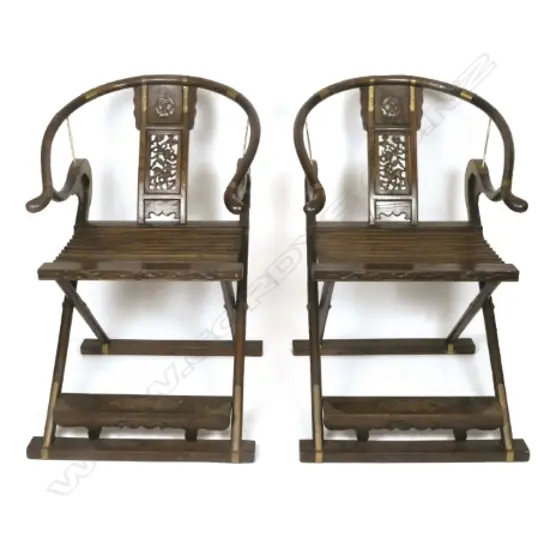 A pair of Chinese hardwood horseshoe-back folding armchairs