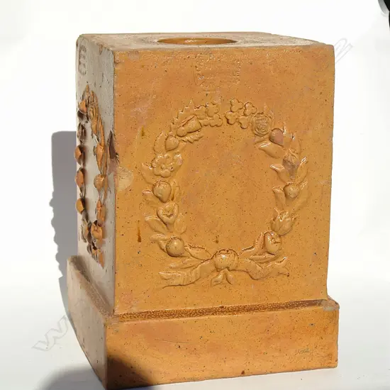 A Carder Bros. decorative plinth stand for a garden urn