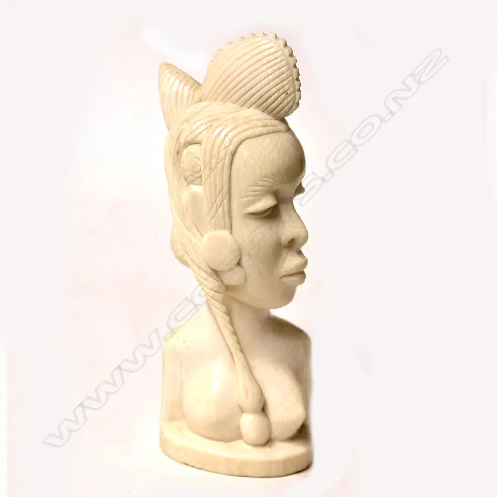 An old African solid carved ivory bust of a young woman Image 1++