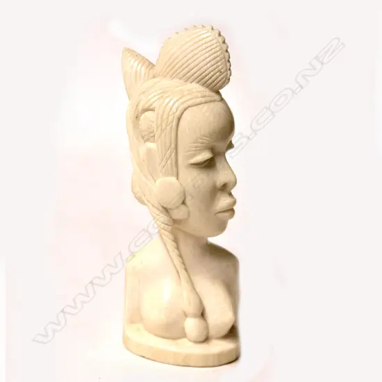 An old African solid carved ivory bust of a young woman