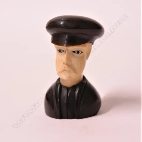 A small carved ivory bust of a gent