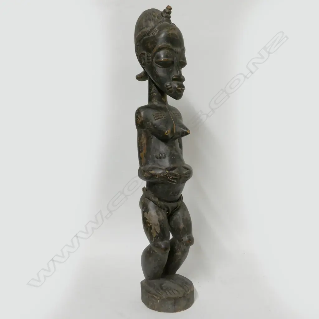 A carved Baoulé female figure Image 1++