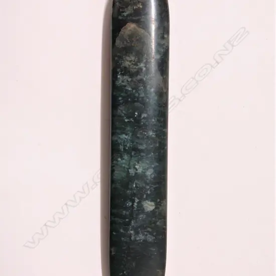An old Maori carved pounamu (bowenite) kuru pendant