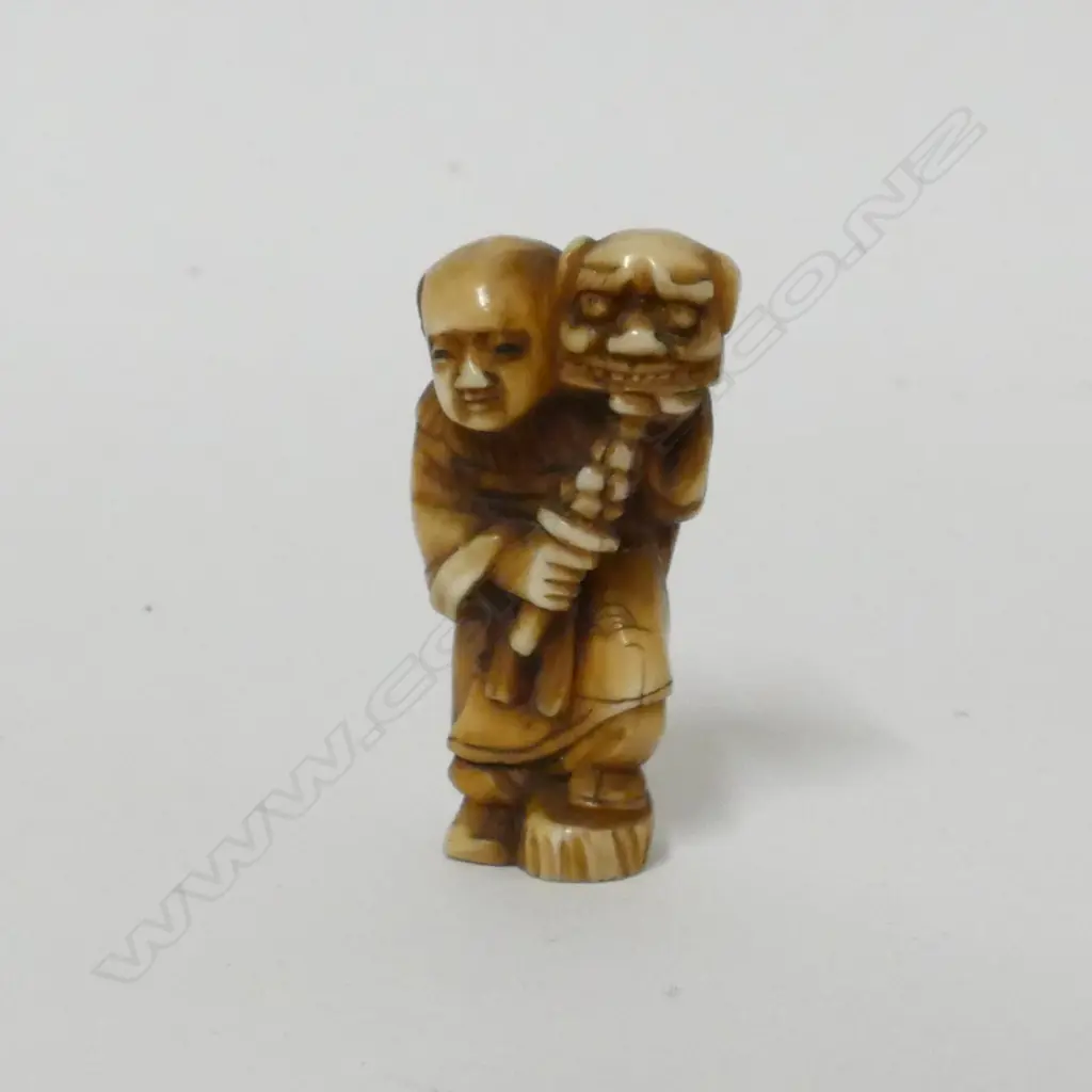 A small old ivory netsuke of a shishimai dancer Image 1++
