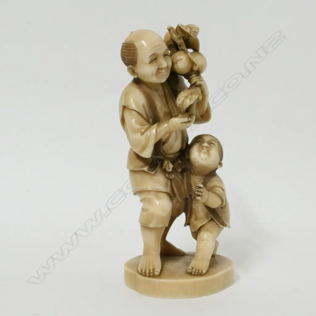 A Japanese ivory okimono of a man and child Image 1++
