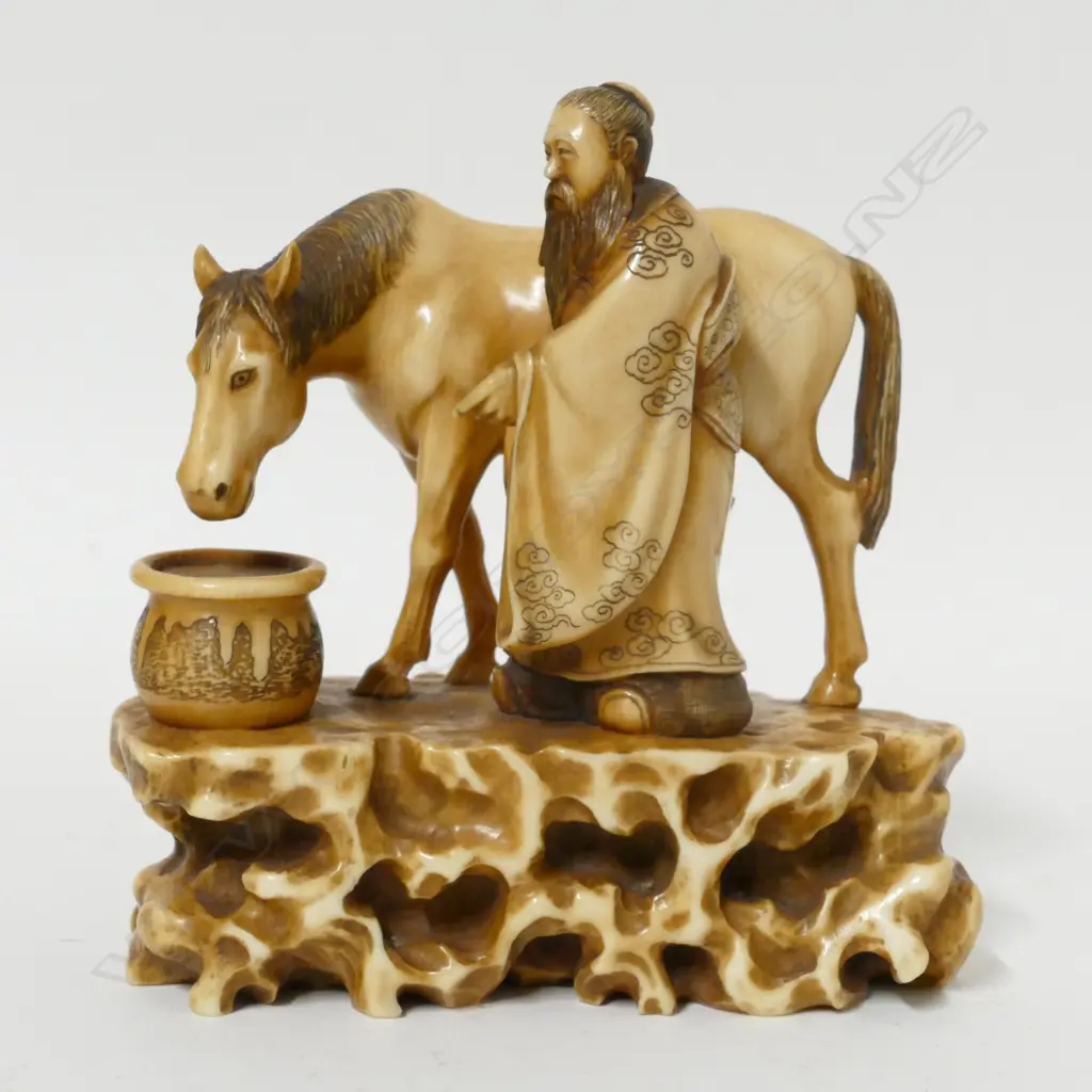 A 19thC ivory okimono of a man watering a horse Image 1++