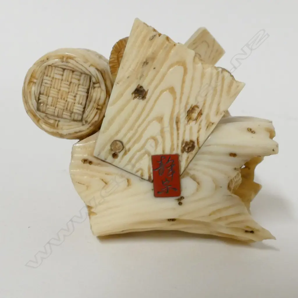 A Japanese Meiji period ivory okimono of a peanut merchant Image 1++