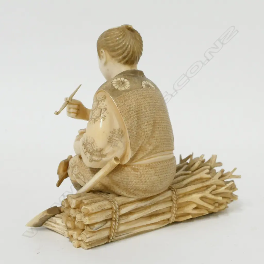 A Japanese Meiji period ivory okimono of a woodsman seated to smoke his kiseru pipe Image 1++