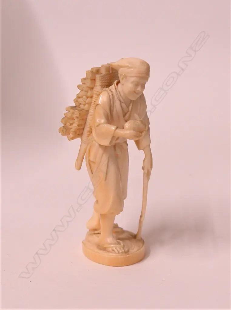 A Japanese Meiji period carved ivory okimono of a woodsman Image 1++