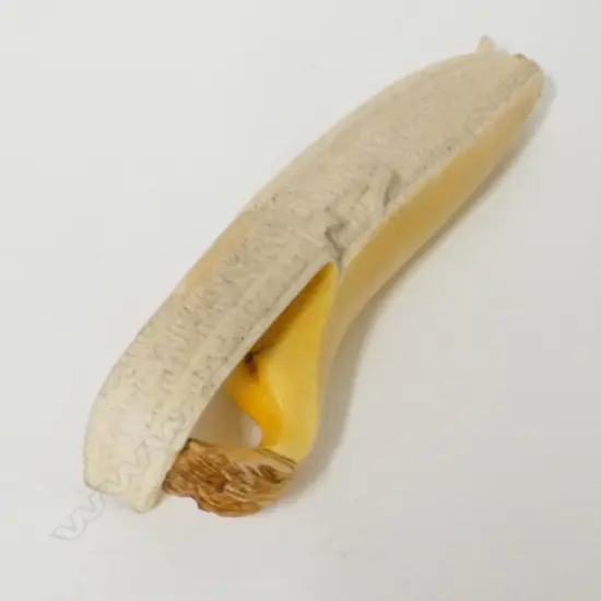 A late Meiji period Japanese ivory okimono carving in the form of a partially peeled banana