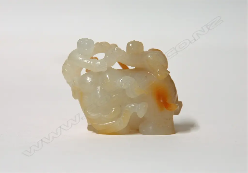 A Chinese Hotan Zi jade carved figure group of an elephant and children Image 1++