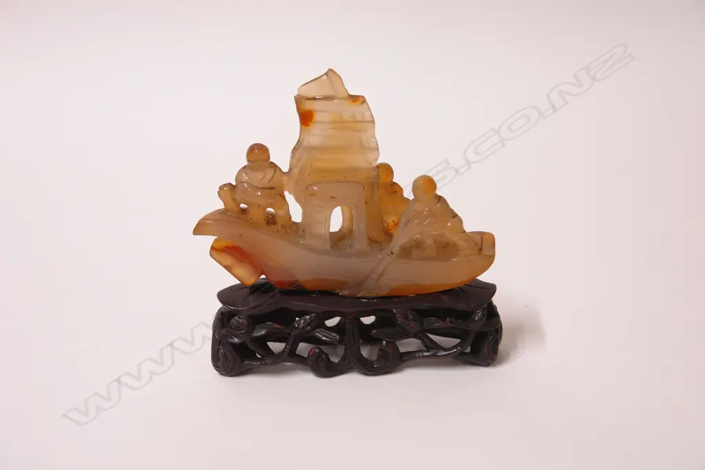 A 19thC Chinese carved agate sculpture of three figures on a boat Image 1++