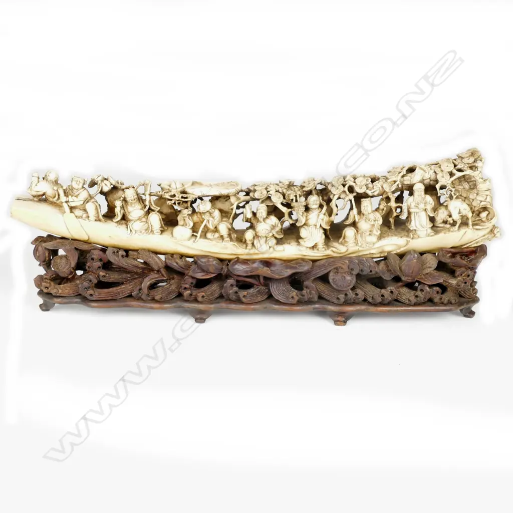 A substantial Chinese Qing period carved ivory tusk depicting the Eight Immortals voyaging to the Feast of Peaches Image 1++