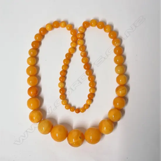 A large Baltic 'egg yolk' amber bead necklace