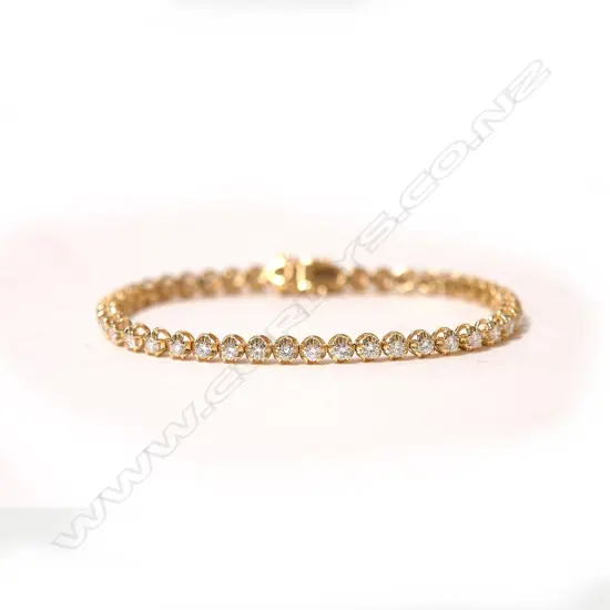 An 18ct. yellow gold and diamond set tennis bracelet