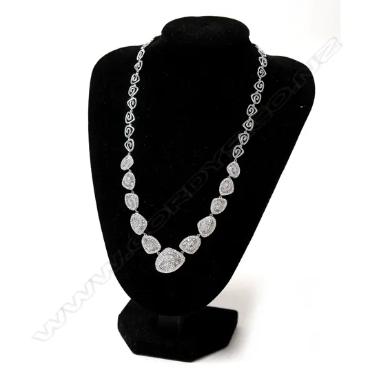 An impressive modern retro style 18ct. white gold and diamond cluster necklace
