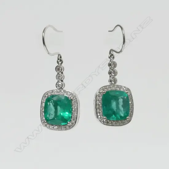 A pair of impressive 18ct white gold emerald and diamond earrings