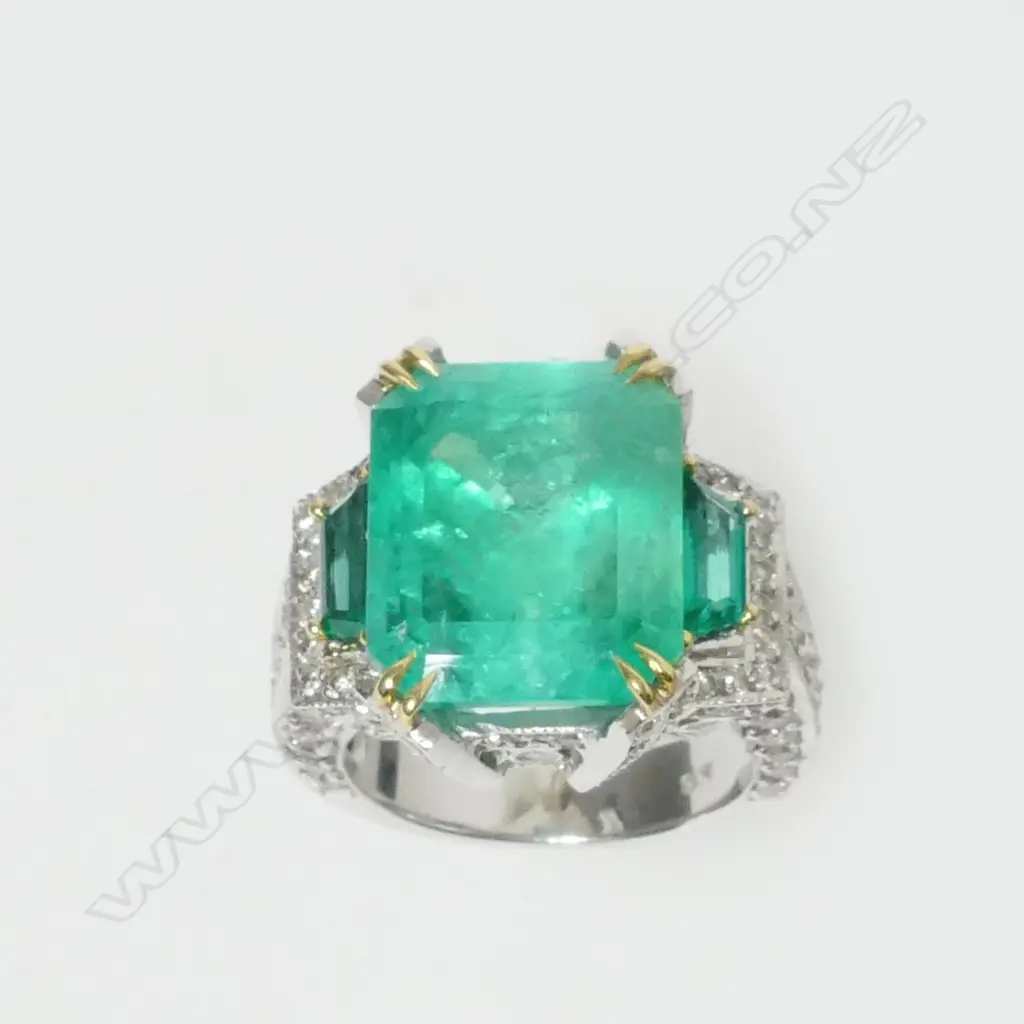 An impressive 18ct. white gold emerald and diamond ring Image 1++