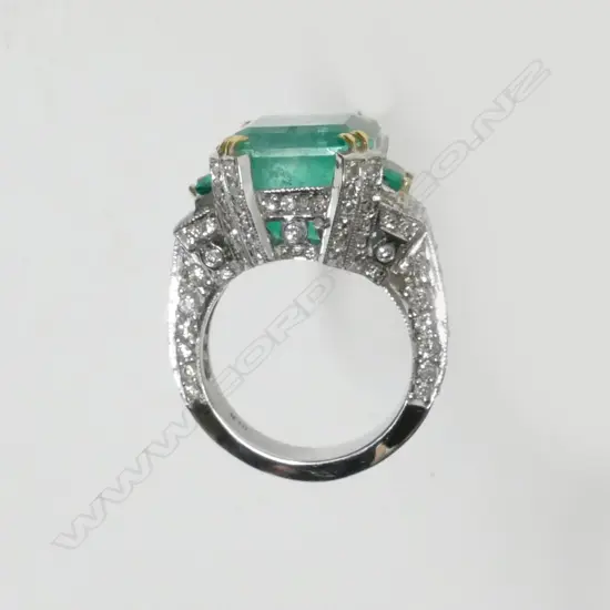 An impressive 18ct. white gold emerald and diamond ring