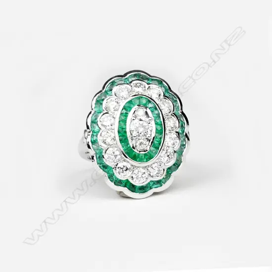 An 18ct. white gold emerald and diamond ring