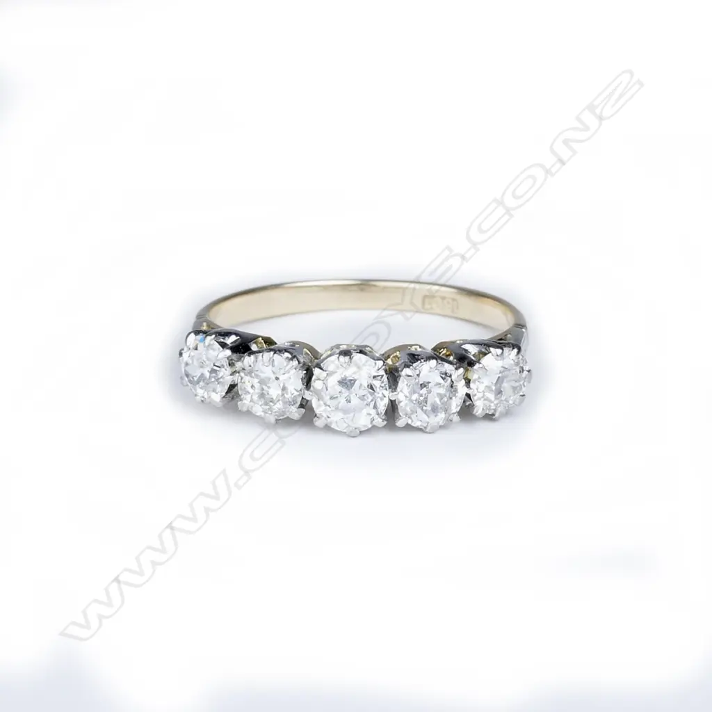 An 18ct. gold and five stone diamond ring Image 1++