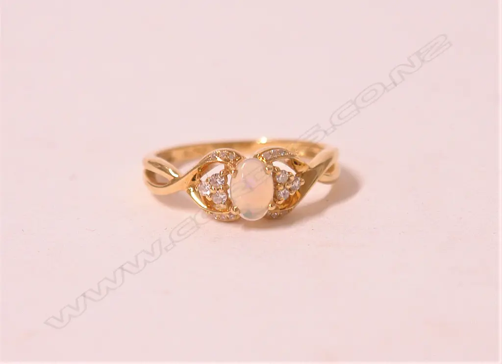 A lady's modern 18ct. yellow gold opal and diamond dress ring Image 1++