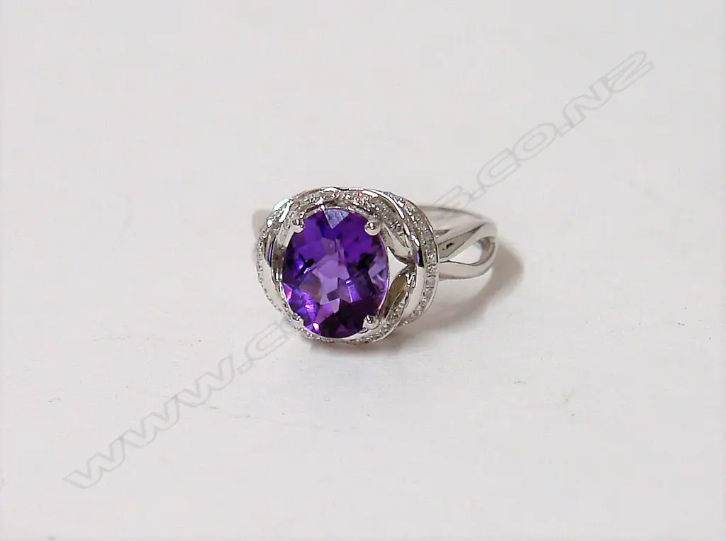 A modern 18ct. white gold amethyst and diamond dress ring Image 1++
