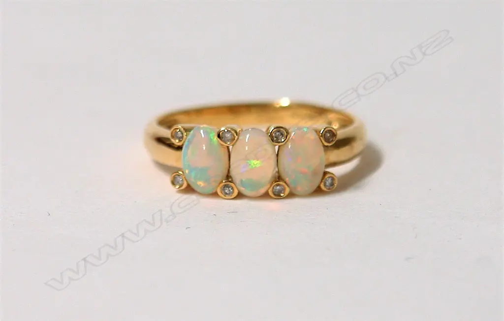 An 18ct. yellow gold opal and diamond modern dress ring Image 1++
