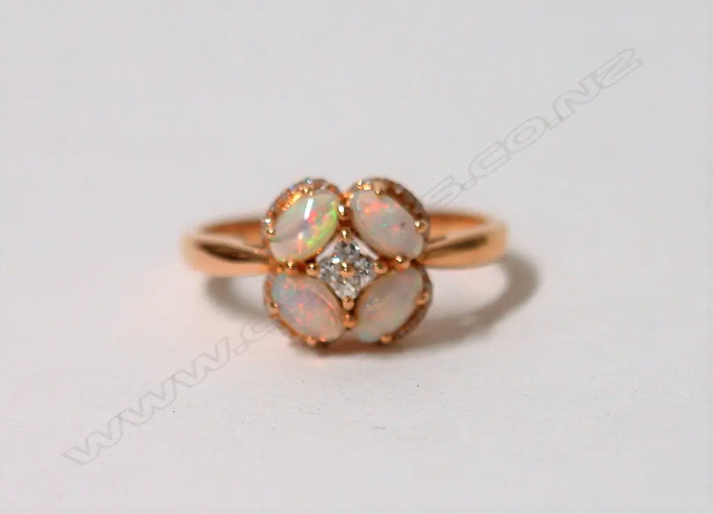 A lady's modern 18ct. rose gold opal and diamond ring Image 1++