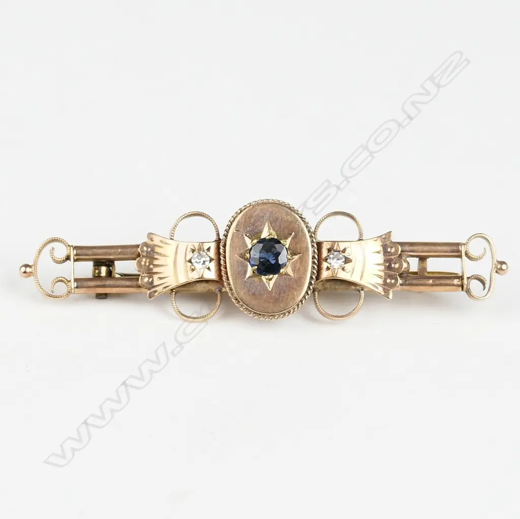 An Edwardian 9ct. rose gold diamond and sapphire bar brooch Image 1++
