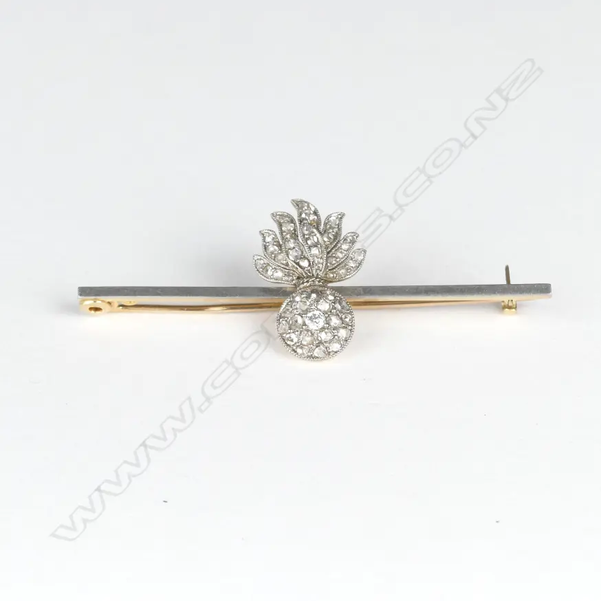 An 18ct. yellow and white gold diamond set military 'Shell and Flame' brooch Image 1++
