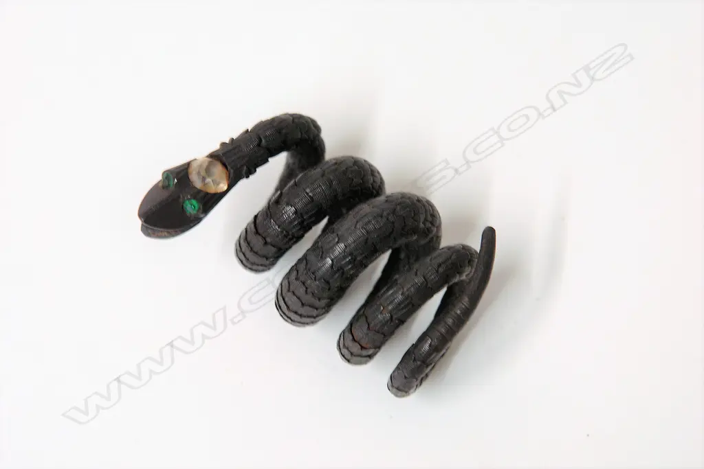 A 19thC sectional carved ebony articulated snake bangle Image 1++