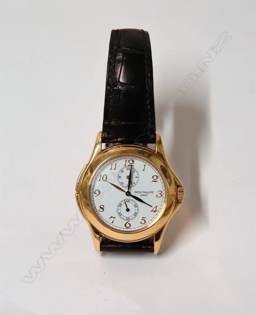 A modern gent's Patek Philippe Travel-Time 5134J 18ct. gold wristwatch Image 1++