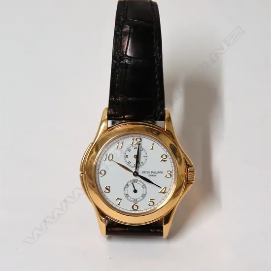 A modern gent's Patek Philippe Travel-Time 5134J 18ct. gold wristwatch
