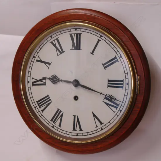A c.1900 American mahogany framed circular school-type wall clock