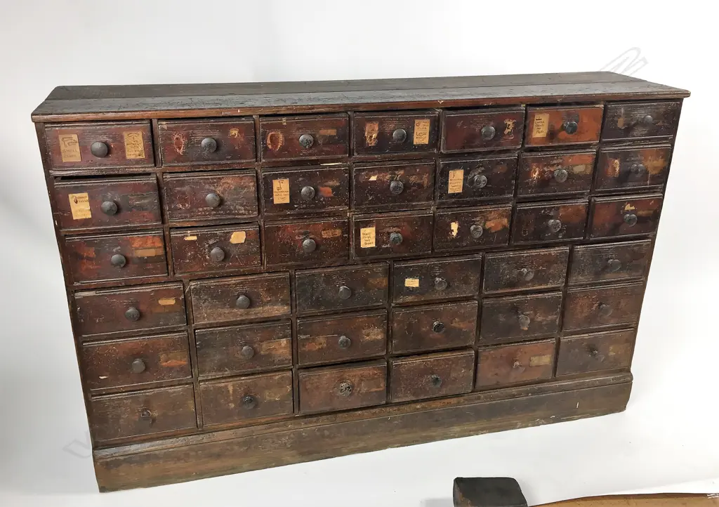 A Victorian dark stained pine multi-drawer shop cabinet Image 1++