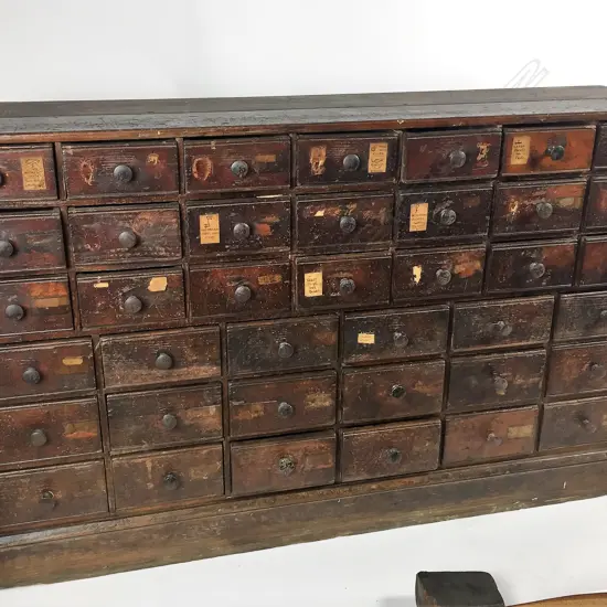 A Victorian dark stained pine multi-drawer shop cabinet