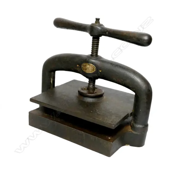 An antique cast iron book press