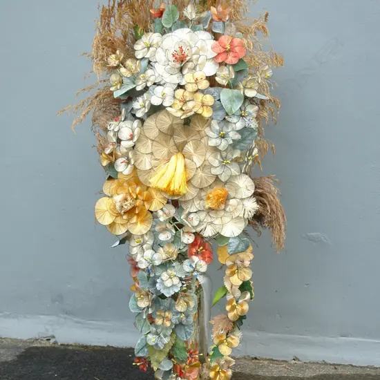 A large early 20thC woven silk floral display in a mercury glass vase