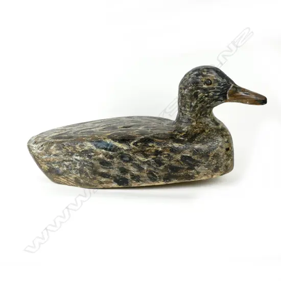 A hand carved balsa hen duck decoy