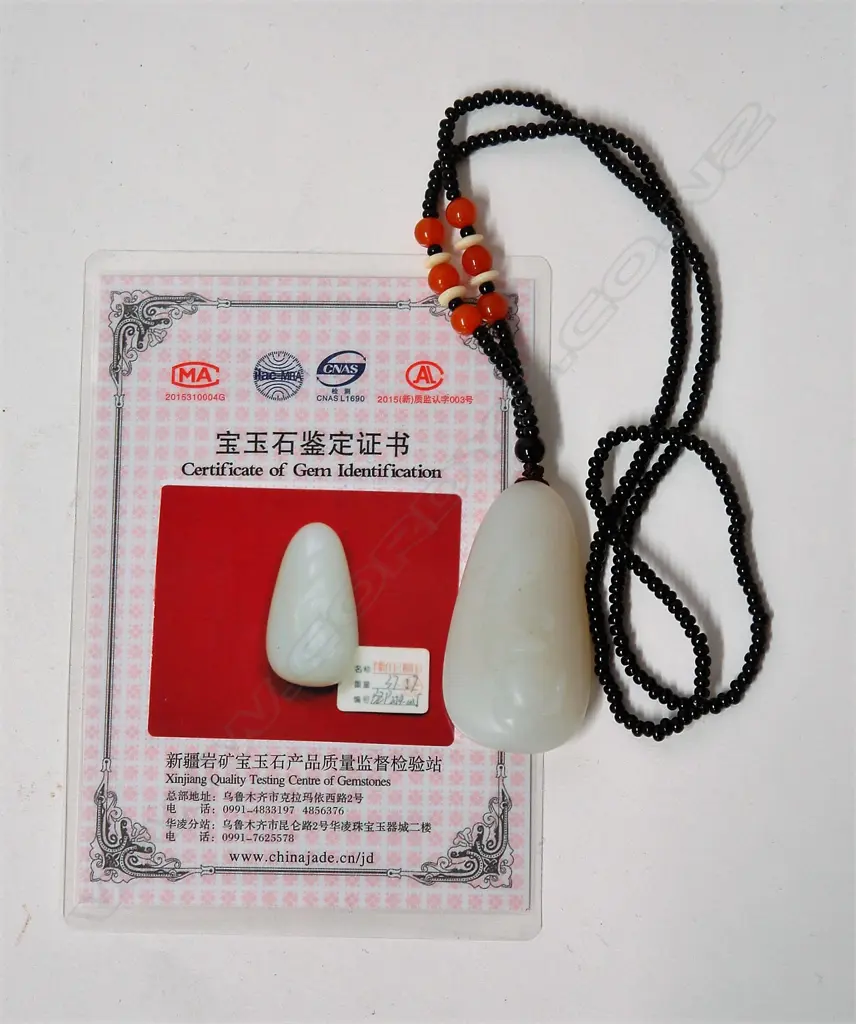 A Chinese pale carved jadeite pendant on bead necklace Image 1++