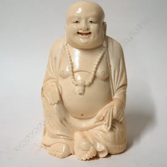 An old Chinese large and solid carved ivory figure of a seated Buddha