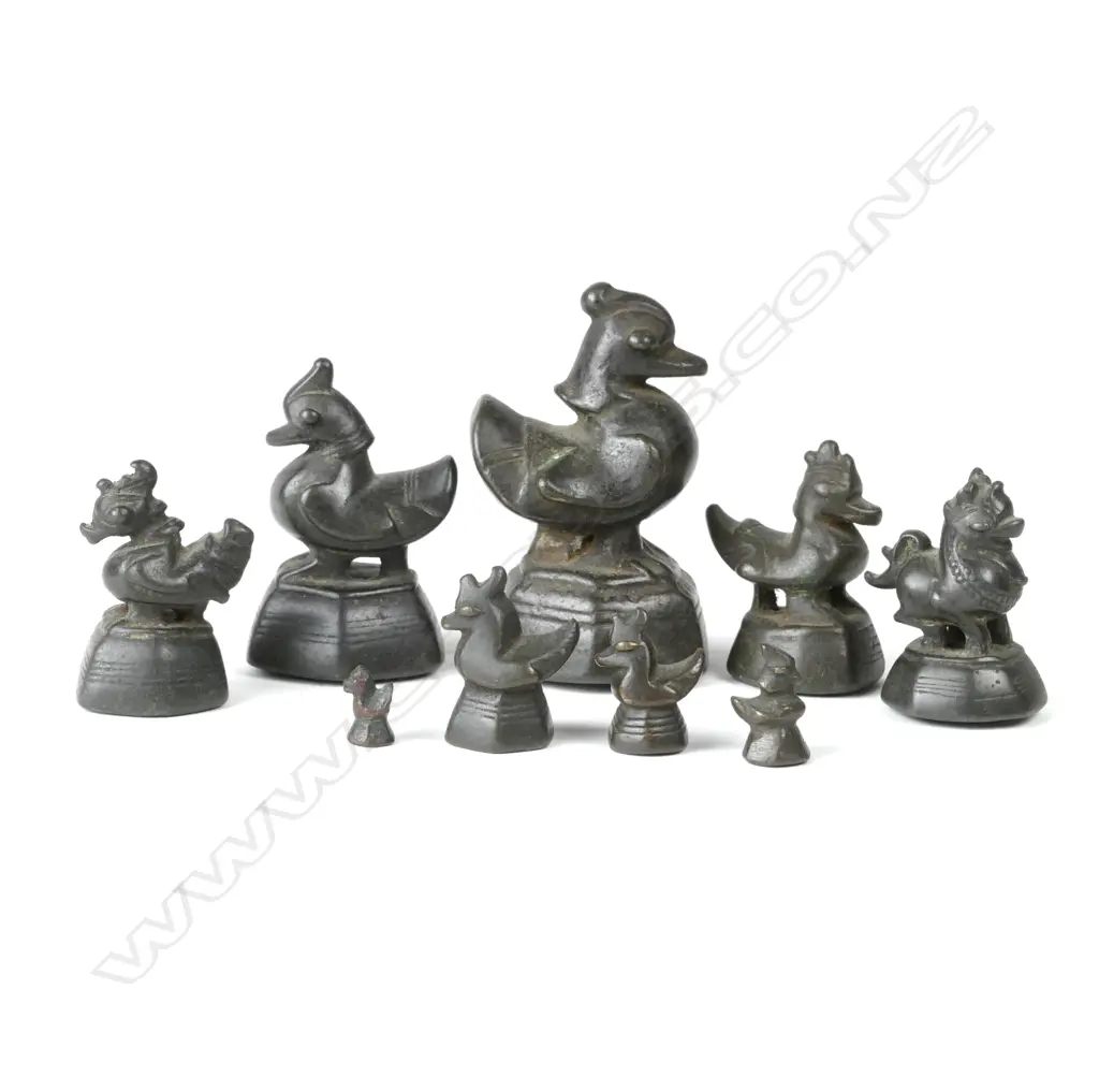 A set of nine antique graduated Burmese bronze bird opium weights Image 1++