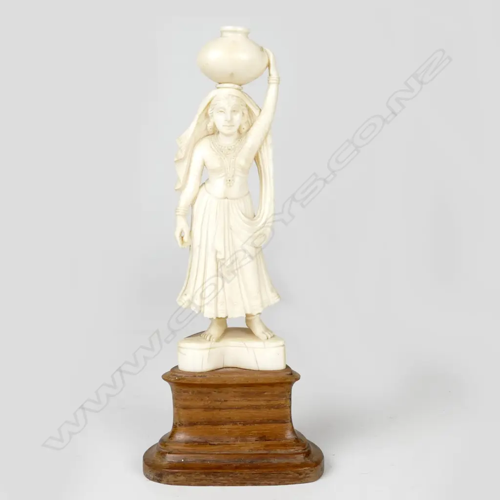 An Indian ivory carving of a woman carrying a water pot on her head Image 1++