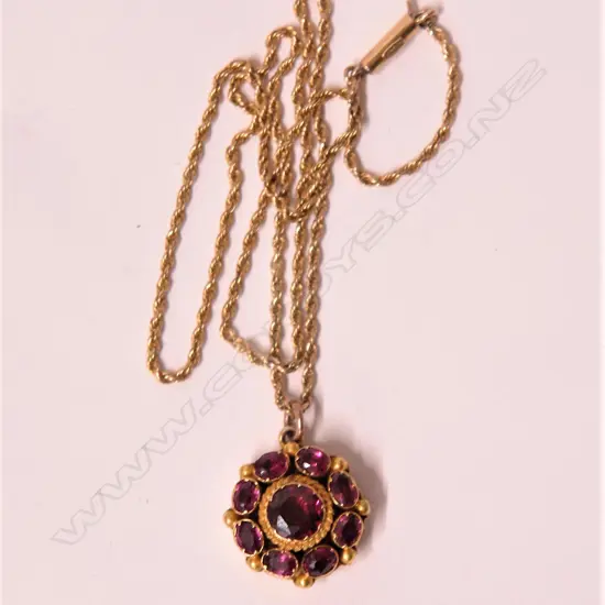 A 19thC 18ct. yellow gold and almandine garnet set pendant on gold chain