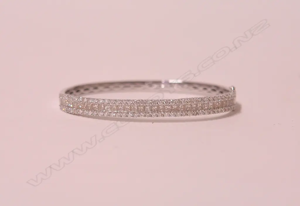 A lady's modern 18ct. white gold and multi-diamond set hinged bangle Image 1++