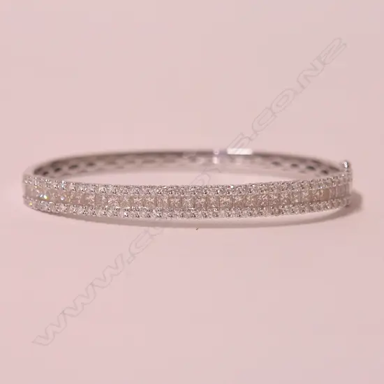 A lady's modern 18ct. white gold and multi-diamond set hinged bangle